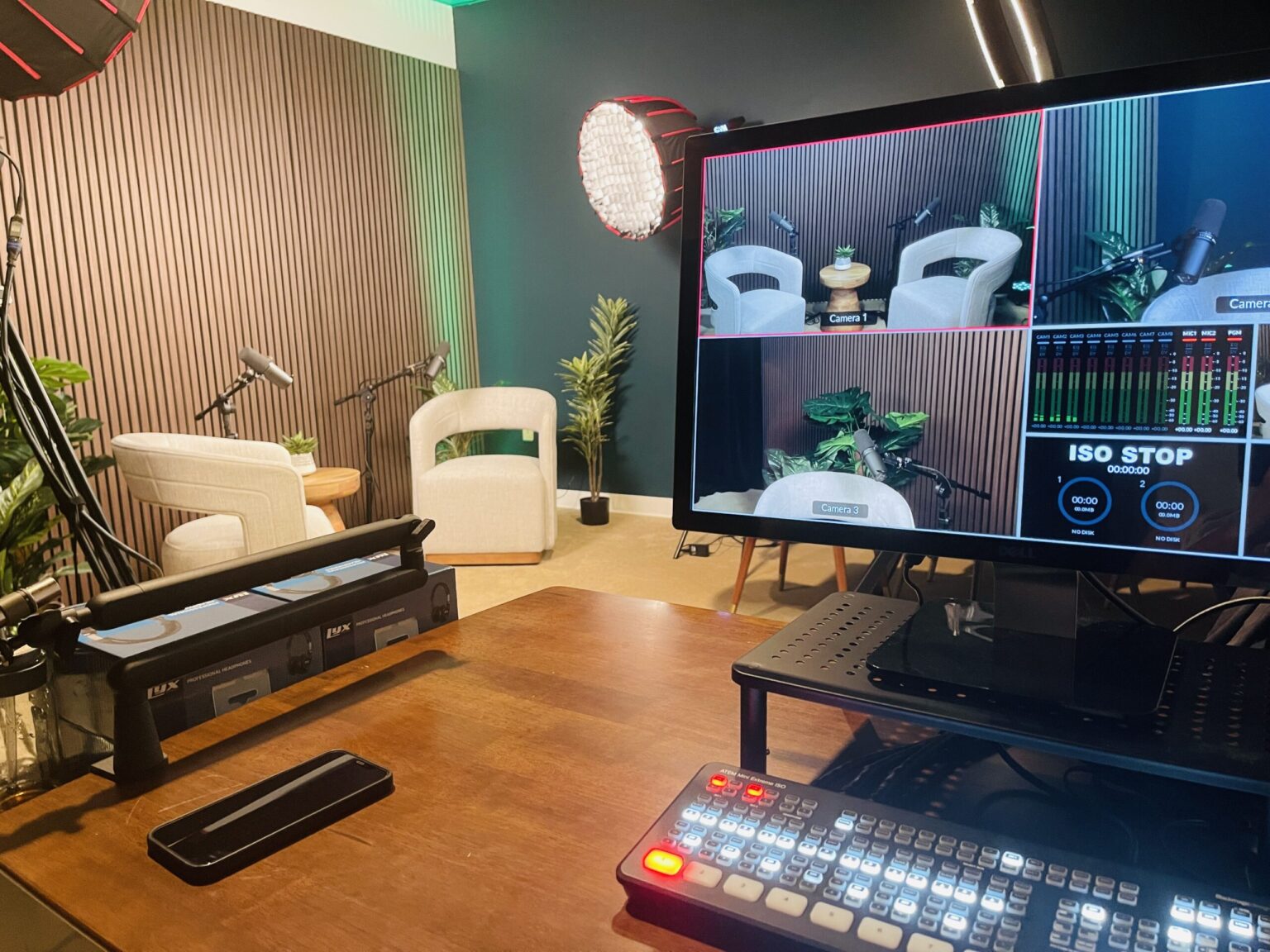 The So Good Media podcast studio set with lounge chairs and a multi-camera switcher